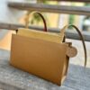 chic little bag with a sleek style and a pretty camel color that goes with every outfit! handmade in Geneva from eco-responsible leathers.